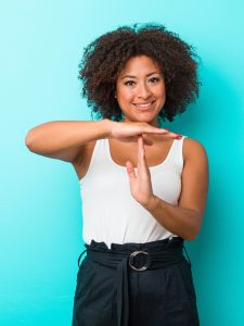 Young african american woman showing a timeout gesture.