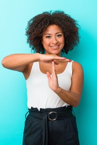 Young african american woman showing a timeout gesture.