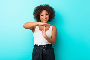 Young african american woman showing a timeout gesture.