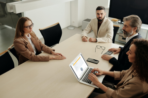 Woman using laptop during meeting